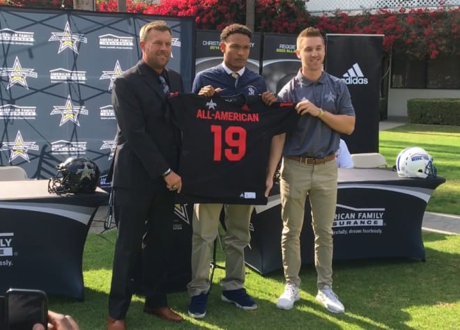 5-star cornerback Chris Steele receives his jersey for the All-American Bowl on Wednesday, joined by St. John Bosco head coach Jason Negro (left) and a representative of the all-star game.