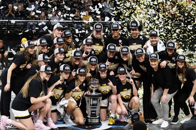 Mar 5, 2023; Minneapolis, MINN, USA; The Iowa Hawkeyes pose for a photo with the trophy after the game against the Ohio State Buckeyes at Target Center. 