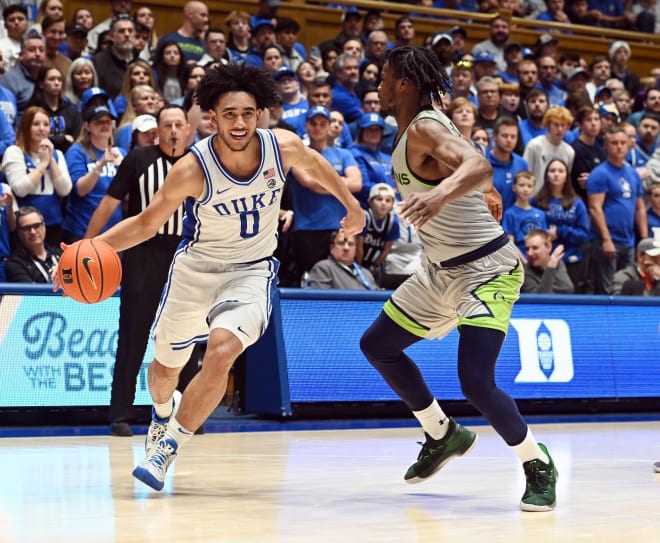 Duke's Jared McCain drives against Queens' AJ McKee during Saturday's game. 