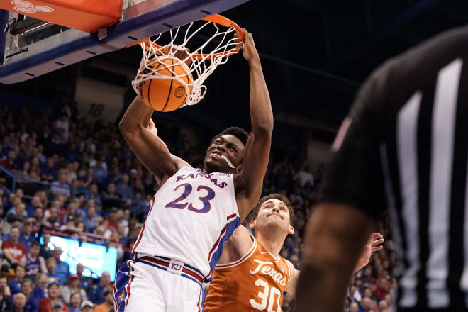 Feb 6, 2023; Lawrence, KS; Kansas Jayhawks center Ernest Udeh Jr. (23) dunks over Texas forward Brock Cunningham (30) in the first half at Allen Fieldhouse.