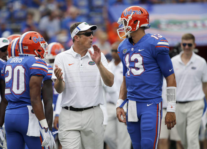 Sep 16, 2017; Gainesville, FL, USA; Florida Gators offensive coordinator Doug Nussmeier talks with quarterback Feleipe Franks (13) before a game against the Tennessee Volunteers at Ben Hill Griffin Stadium.