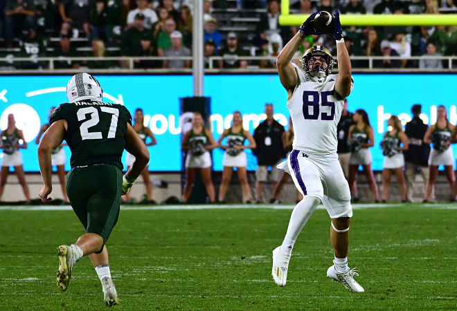 Washington Huskies tight end Josh Cuevas (85) pulls in a pass against Michigan State Spartans linebacker Cal Haladay (27) in the third quarter at Spartan Stadium. Photo | Dale Young-USA TODAY Sports