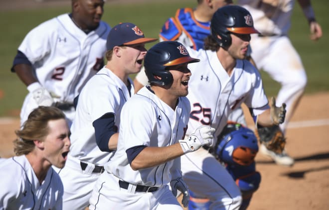 Auburn players celebrate the walk-off win and three-game sweep of No. 5 Florida.