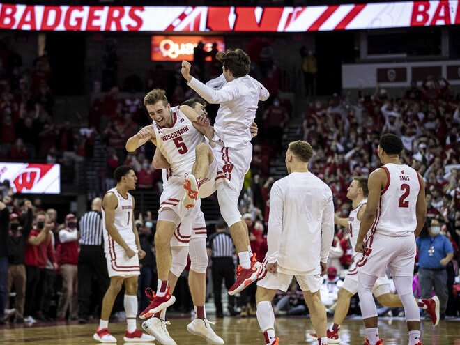 Tyler Wahl (5) is in the middle of a post-game celebration for Wisconsin, which stormed back from 22 points down to knock off Indiana.