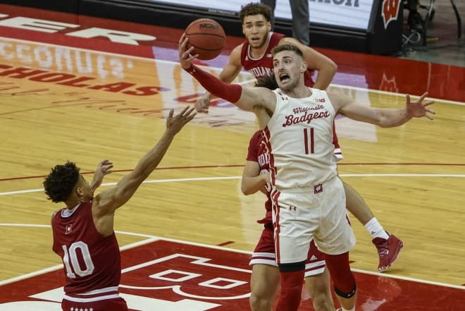 Wisconsin forward Micah Potter hauls in a rebound during the Badgers' double overtime win against Indiana.