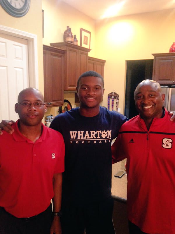 DeVontres Dukes with Wolfpack assistants Des Kitchings (left) and George McDonald (right) during an in-home visit.