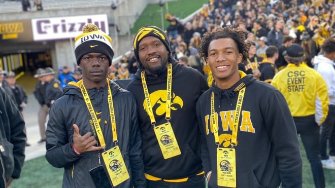 Keylen Gulley, left, and Quavon Matthews, right, with their coach Marcus Paschal at Kinnick Stadium.