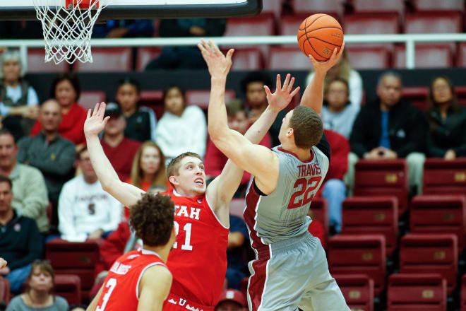 Utah Runnin' Utes forward Tyler Rawson (21) attempts to defend against Stanford Cardinal forward Reid Travis (22) during the second half of the game at Maples Pavilion.