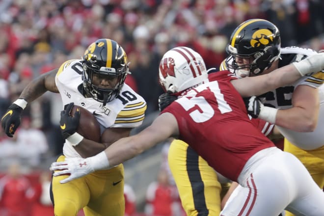 Iowa's Mekhi Sargent runs past Wisconsin's Jack Sanborn during the first half of the Badgers' 24-22 win over the Hawkeyes in 2019.