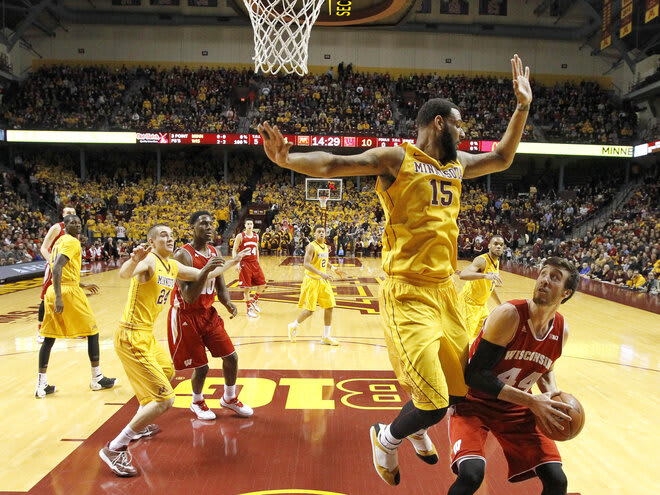 Wisconsin forward Frank Kaminsky (44) goes to the basket under pressure from Minnesota forward Maurice Walker (15). UW won, 76-63, to clinch the outright conference title.