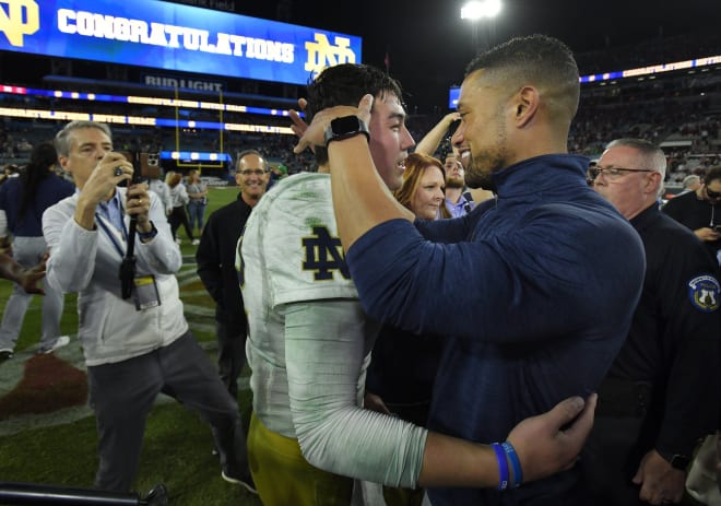 Quarterback Tyler Buchner (left) and Notre Dame head coach Marcus Freeman embrace after ND's Gator Bowl victory over South Carolina on Dec. 30.