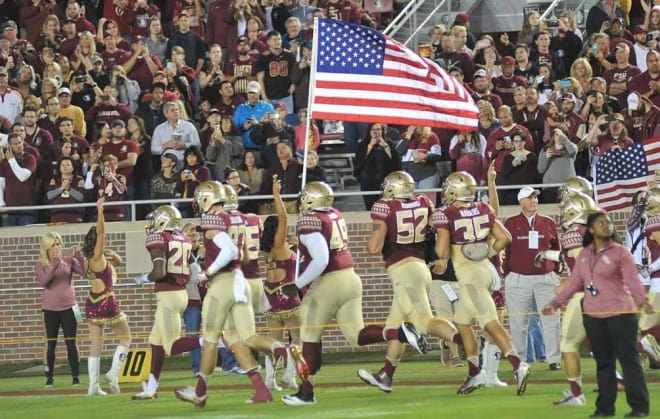 Florida State runs out with the American flag prior to its win over Boston College on Friday evening at Doak Campbell Stadium.