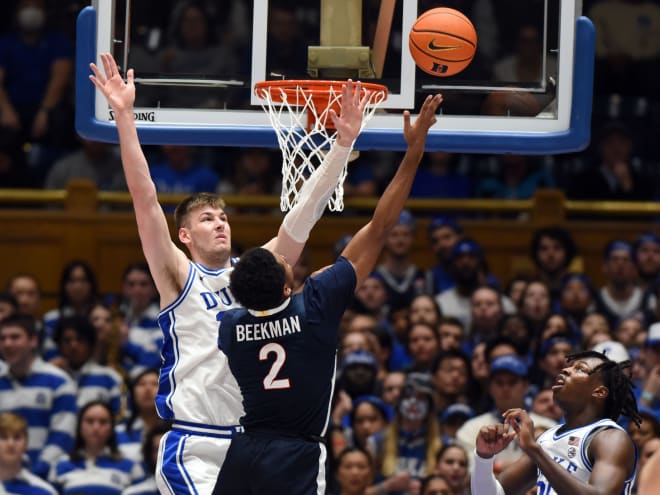 Duke's Kyle Filipowski defends a shot at the basket by Reece Beekman. 