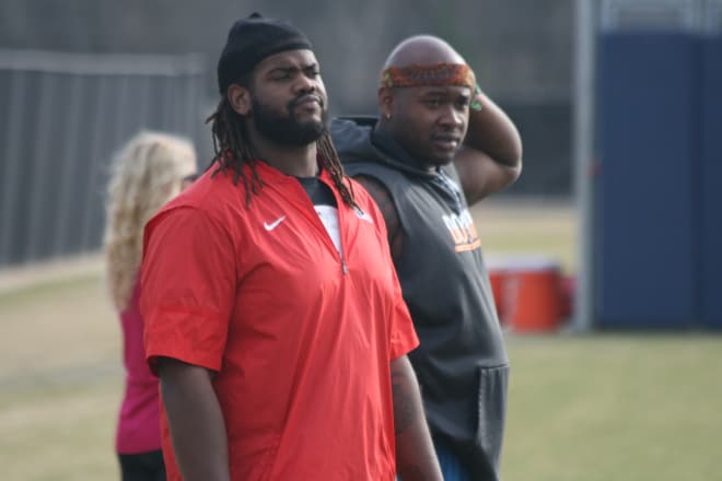 Former Ole Miss offensive linemen Fahn Cooper (left) and Laremy Tunsil look on during the Rebels' practice Tuesday.
