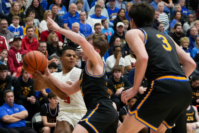 Fishers Tigers Jason Gardner Jr. (5) looks for an open teammate while a Carmel Greyhound defender knocks the ball out of his hands, Tuesday, Feb. 27, 2024, during the Class 4A sectional game at Noblesville High School in Noblesville, Indiana. Fishers beat Carmel 54-41 and advances to play the Hamilton Southeastern Royals in the Class 4A semifinals game on March 1. © Joe Timmerman/IndyStar / USA TODAY NETWORK