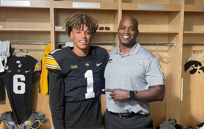 Class of 2025 prospect Talyn Taylor with Iowa wide receivers coach Kelton Copeland.