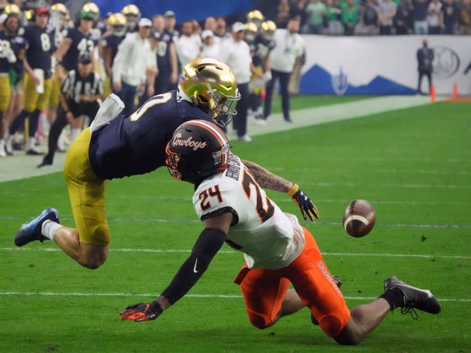 Notre Dame wide receiver Braden Lenzy can't haul in a pass from quartback Jack Coan with Oklahoma State's Jarrick Bernard-Converse in coverage.