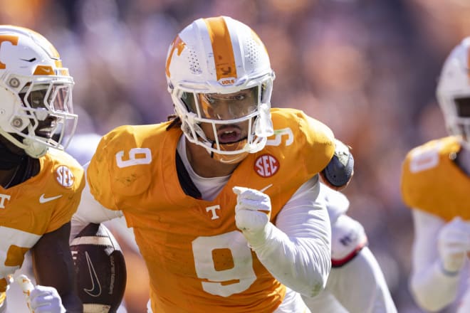 Tennessee defensive lineman Tyler Baron (9) returns a fumble for a touchdown during the first half of an NCAA college football game against UConn, Saturday, Nov. 4, 2023, in Knoxville, Tenn. (AP Photo/Wade Payne)