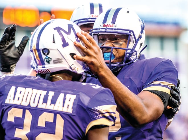 Former James Madison quarterback Vad Lee (right, shown during a 2015 game) has quit playing and joined the Indiana football program as team chaplain.