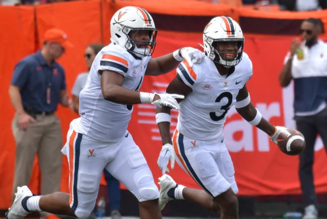 Virginia's Nick Jackson, left, and Anthony Johnson celebrate after an interception against Illinois. 