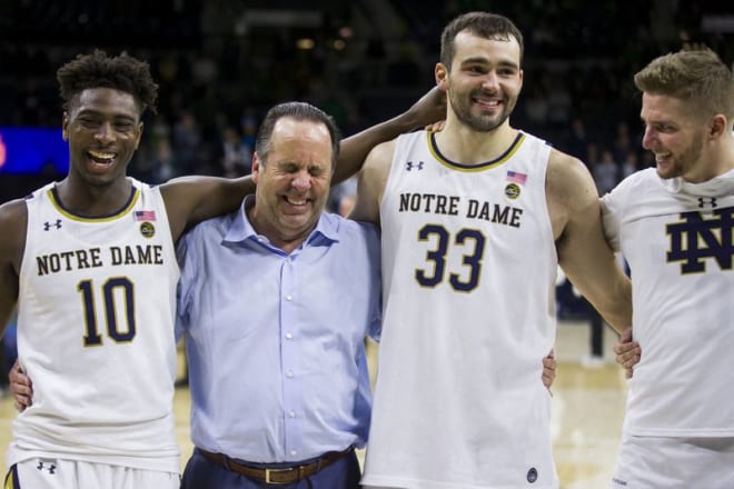 Notre Dame men’s basketball head coach Mike Brey with T.J. Gibbs, John Mooney and Rex Pflueger