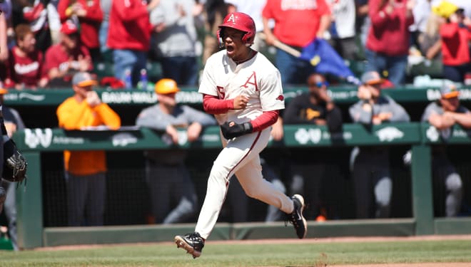 Kendall Diggs pumps his fists, scoring the third run on a Brady Slavens bases-clearing triple during the Razorbacks' 7-2 victory over the Volunteers.