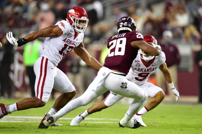 Julius Coates and Gregory Brooks Jr. trap Aggie running back Isaiah Spiller.