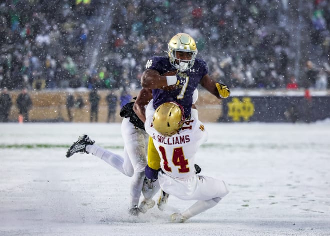 Notre Dame running back Audric Estimé (7) bowls over a defender during a 44-0 Irish victory over Boston College on Nov. 19.