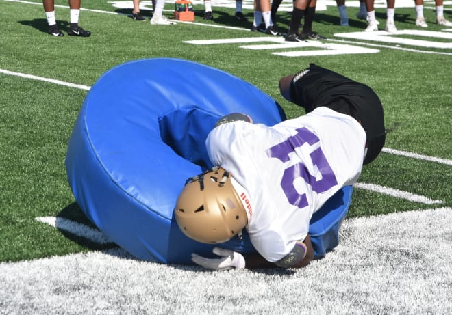 James Madison safety Adam Smith tackles a bag during Dukes practice earlier this week at Bridgeforth Stadium.