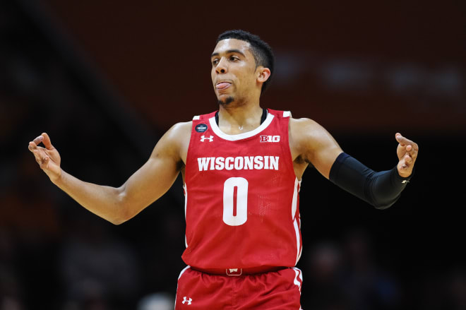 Wisconsin Badgers guard D'Mitrik Trice (0) celebrates after hitting a three pointer against Tennessee.