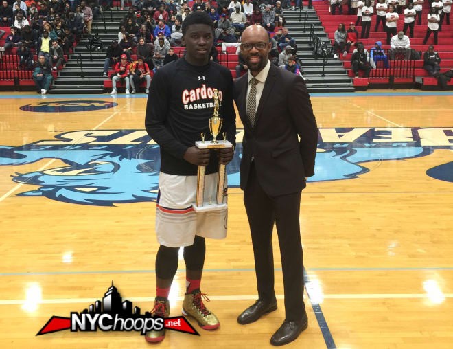 Salnave holding MVP hardware with Big Apple Basketball president & founder Jason Curry