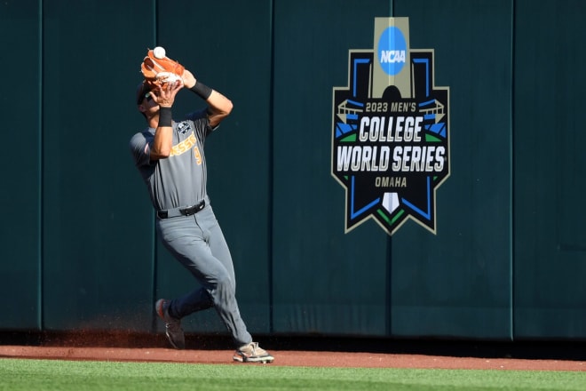 Tennessee outfielder Hunter Ensley (9) catches a ball hit by LSU outfielder Dylan Crews (3) at the wall during a NCAA College World Series elimination game between Tennessee and LSU at Charles Schwab Field in Omaha, Neb. on Tuesday, June 20, 2023.