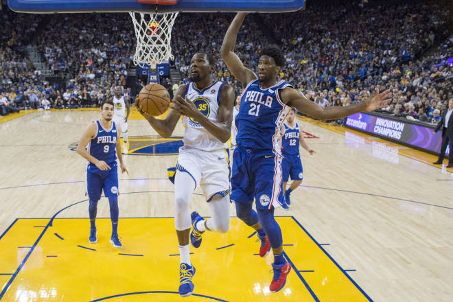 Golden State Warriors forward Kevin Durant (35) shoots the basketball against Philadelphia 76ers center Joel Embiid (21) during the first half at Oracle Arena. The Warriors defeated the 76ers 135-114. 