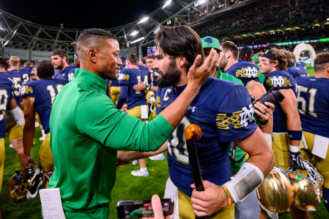 Irish head coach Marcus Freeman congratulates QB Sam Hartman after his triumphant Notre Dame debut.