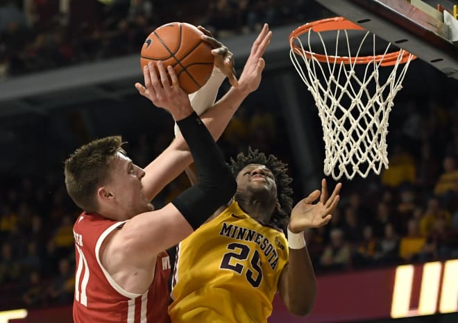 Wisconsin's Micah Potter (11) shoots against Minnesota's Daniel Oturu (25) during the second half 