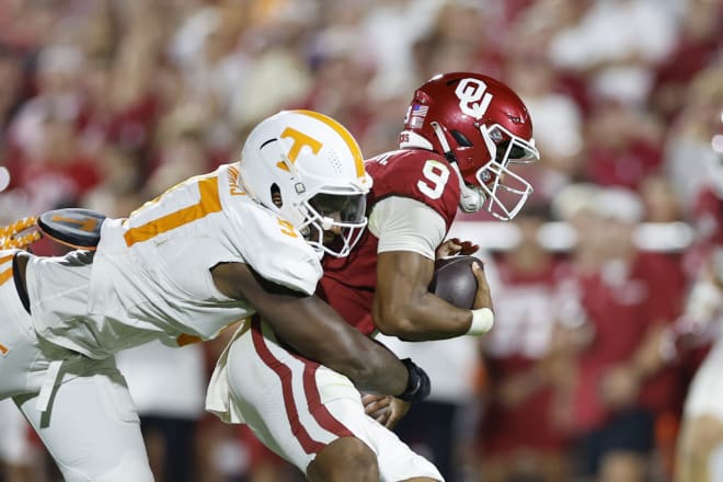 Tennessee defensive lineman Jayson Jenkins (97) tackles Oklahoma quarterback Michael Hawkins Jr. (9) during the second half of an NCAA college football game Saturday, Sept. 21, 2024, in Norman, Okla. (AP Photo/Alonzo Adams)