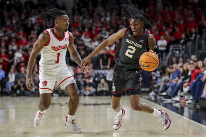 Javian McCollum (2) being defended by Cincinnati's Day Day Thomas (1)