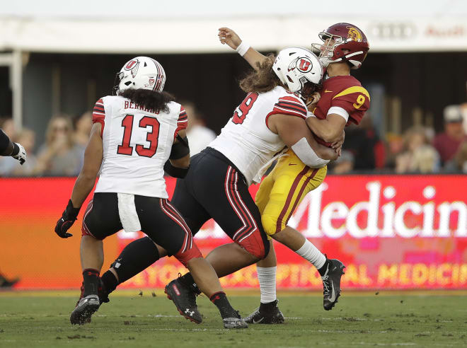 Utah's Leki Fotu drills QB Kedon Slovis as he gets off a completion to Amon-Ra St. Brown. Slovis would hit the back of his helmet hard on the ground as he fell and be placed in the concussion protocol, ending his night after two plays.