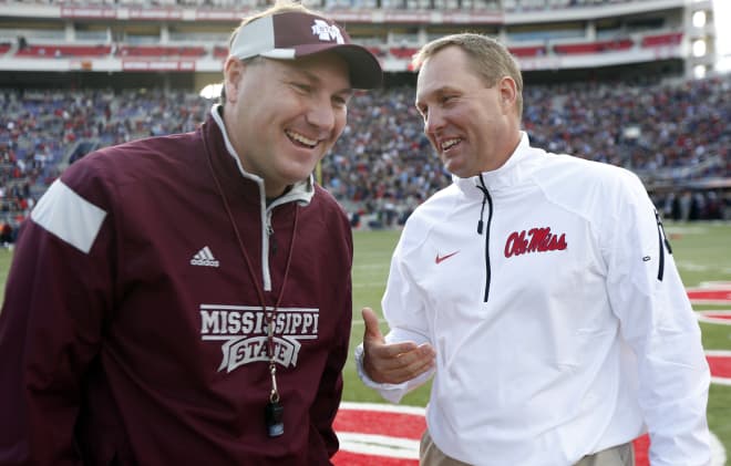 Mississippi State coach Dan Mullen and Ole Miss coach Hugh Freeze meet before the 2014 Egg Bowl in Oxford.