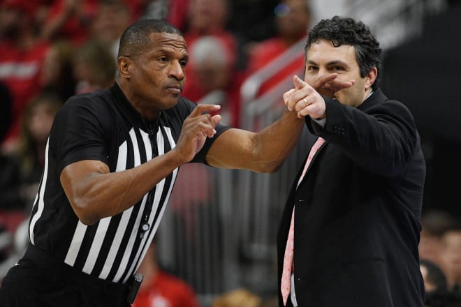 Referee Ted Valentine makes contact with former Georgia Tech coach Josh Pastner during a game in 2022. 