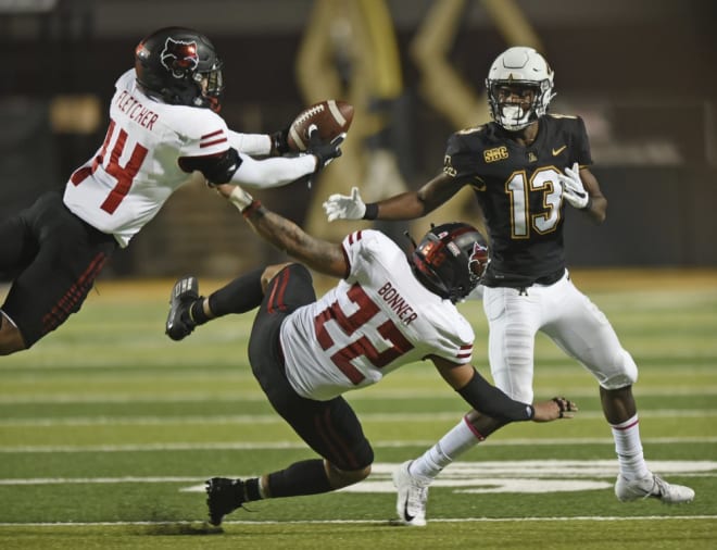 Arkansas State defensive back Antonio Fletcher, left, intercepts a pass intended for Appalachian State wide receiver Christian Horn