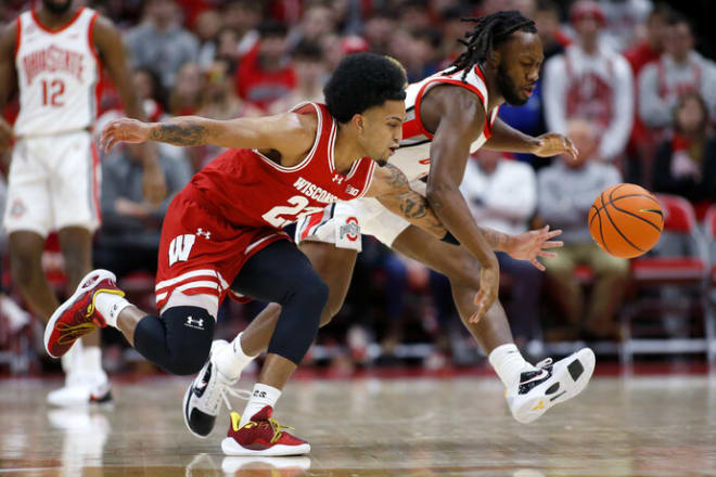 Wisconsin Badgers guard Chucky Hepburn (23) goes for the ball with Ohio State Buckeyes guard Bruce Thornton (2) 