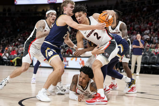 Dec 21, 2022; Athens, Georgia, USA; Notre Dame Fighting Irish guard Dane Goodwin (23) and Georgia Bulldogs forward KyeRon Lindsay (2) fight for a loose ball during the second half at State Farm Arena.