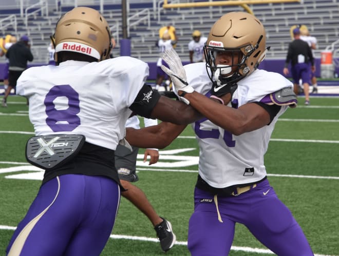 James Madison safety Adam Smith (right) works against spur Wayne Davis during a drill at Dukes practice last week in Harrisonburg.