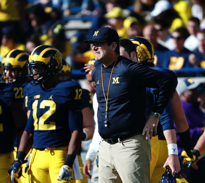 Michigan Wolverines football coach Jim Harbaugh and his team improved to 2-0 with a win over Washington