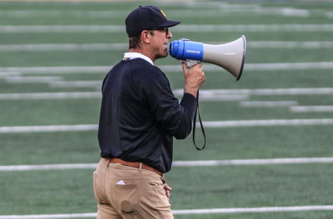 Jim Harbaugh continues overseeing the Wolverines in practice, without knowing if they'll play a game.