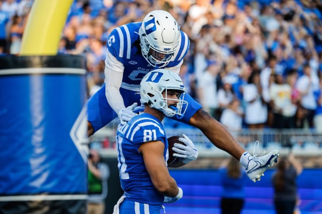Duke's Eli Pancol, top, and Nicky Dalmolin celebrate after Dalmolin scored a touchdown earlier this season. 