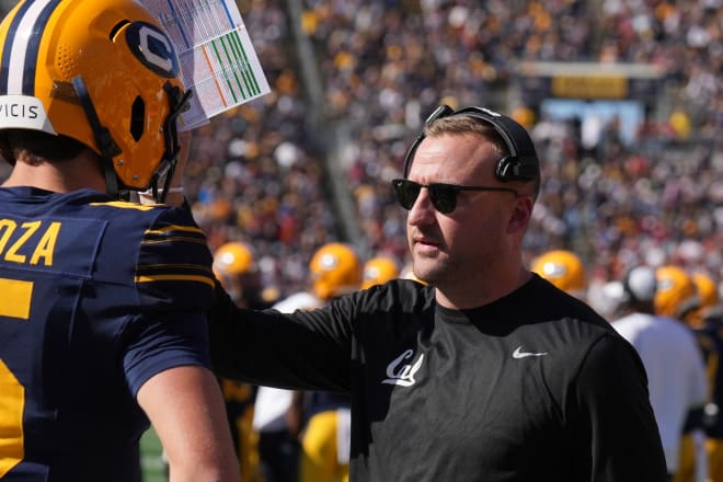 Cal offensive coordinator Jake Spavital talks with quarterback Fernando Mendoza during a game earlier this season.