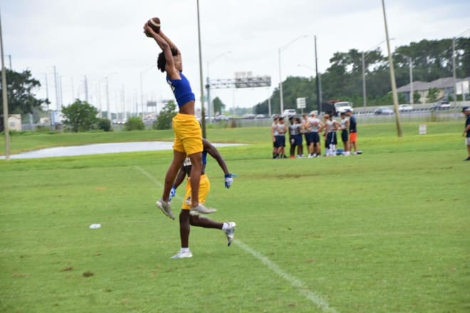 Weaver goes up for a pass during summer workouts at his school