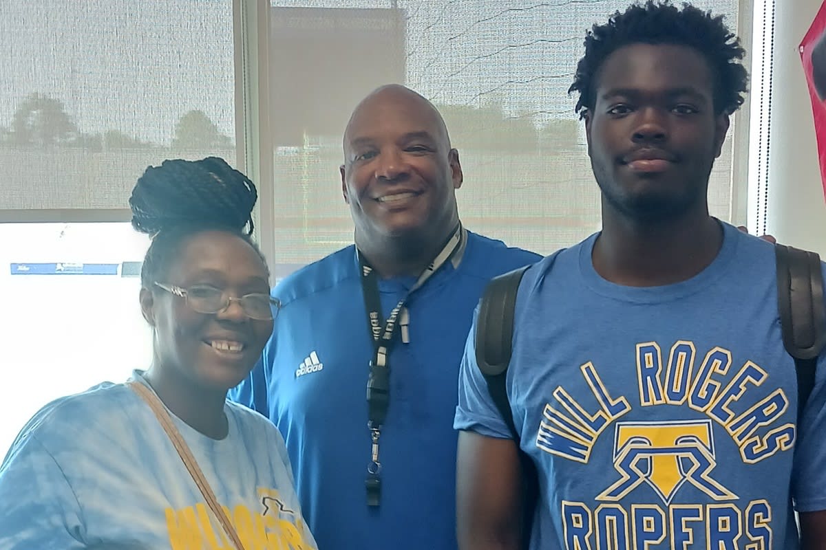 Josiah Hammond with Tulsa assistant coach Ron Burton.